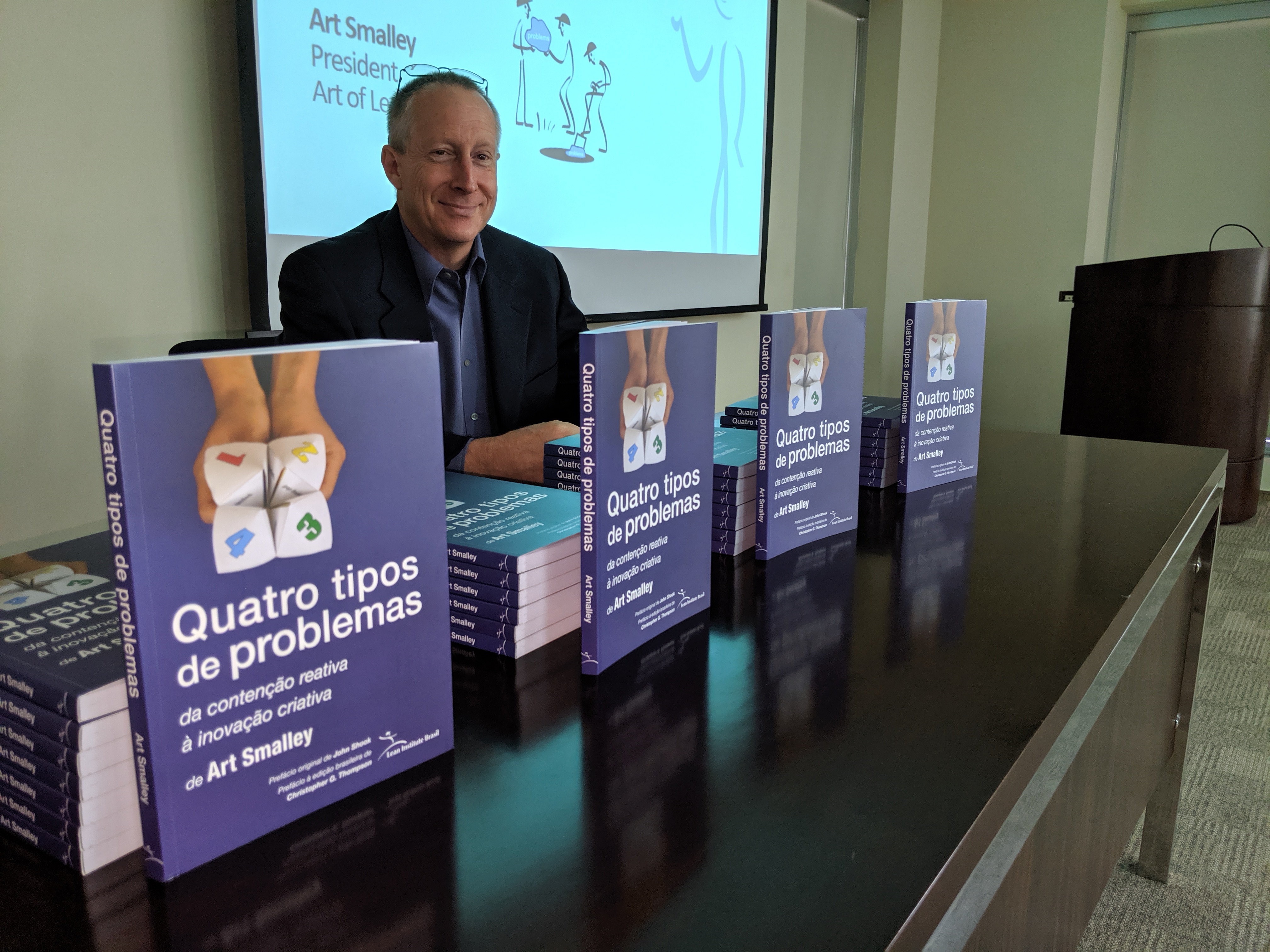 Art Smalley at a book signing with copies of Four Types of Problems
